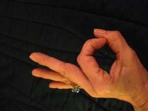 Palm faces up, Press thumb over first finger. Left Hand Mudra!
