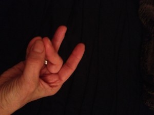 Palm faces up, Pads of Thumb, pinkie and middle finger press together. Right Hand Mudra!